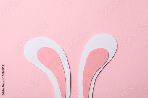 Decorative bunny ears on pink background, space for text