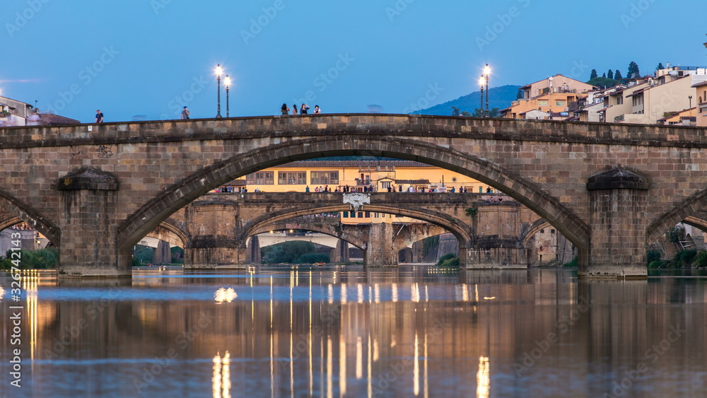 Twilight sky scene of Ponte Alla Carraia and Santa Trinita Holy Trinity Bridge day to night timelapse over River Arno