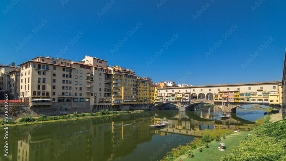 View on The Ponte Vecchio on a sunny day timelapse , a medieval stone segmental arch bridge over the Arno River, in Florence, Italy