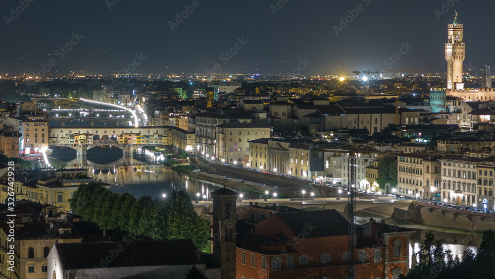 Famous Arnolfo tower of Palazzo Vecchio timelapse and Arno River at night in Florence, Tuscany, Italy