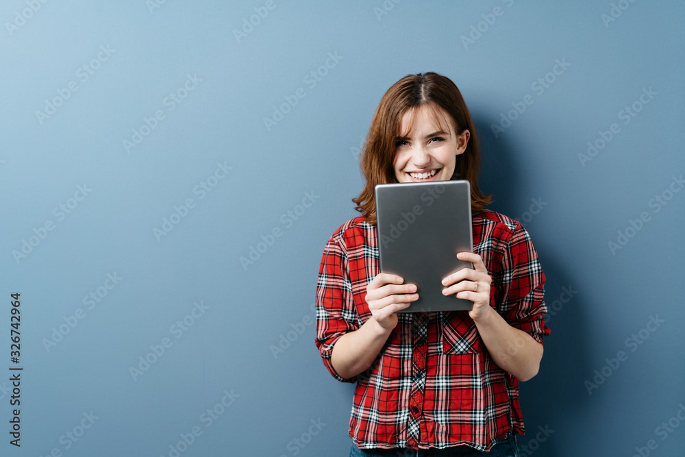 Cute young woman holding a tablet computer Cute young woman holding a tablet computer