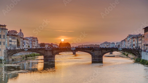 Cityscape view on Arno river with famous Holy Trinity bridge timelapse on the sunset in Florence © neiezhmakov