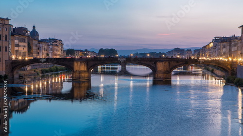 Twilight sky scene of Ponte Santa Trinita Holy Trinity Bridge day to night timelapse over River Arno © neiezhmakov