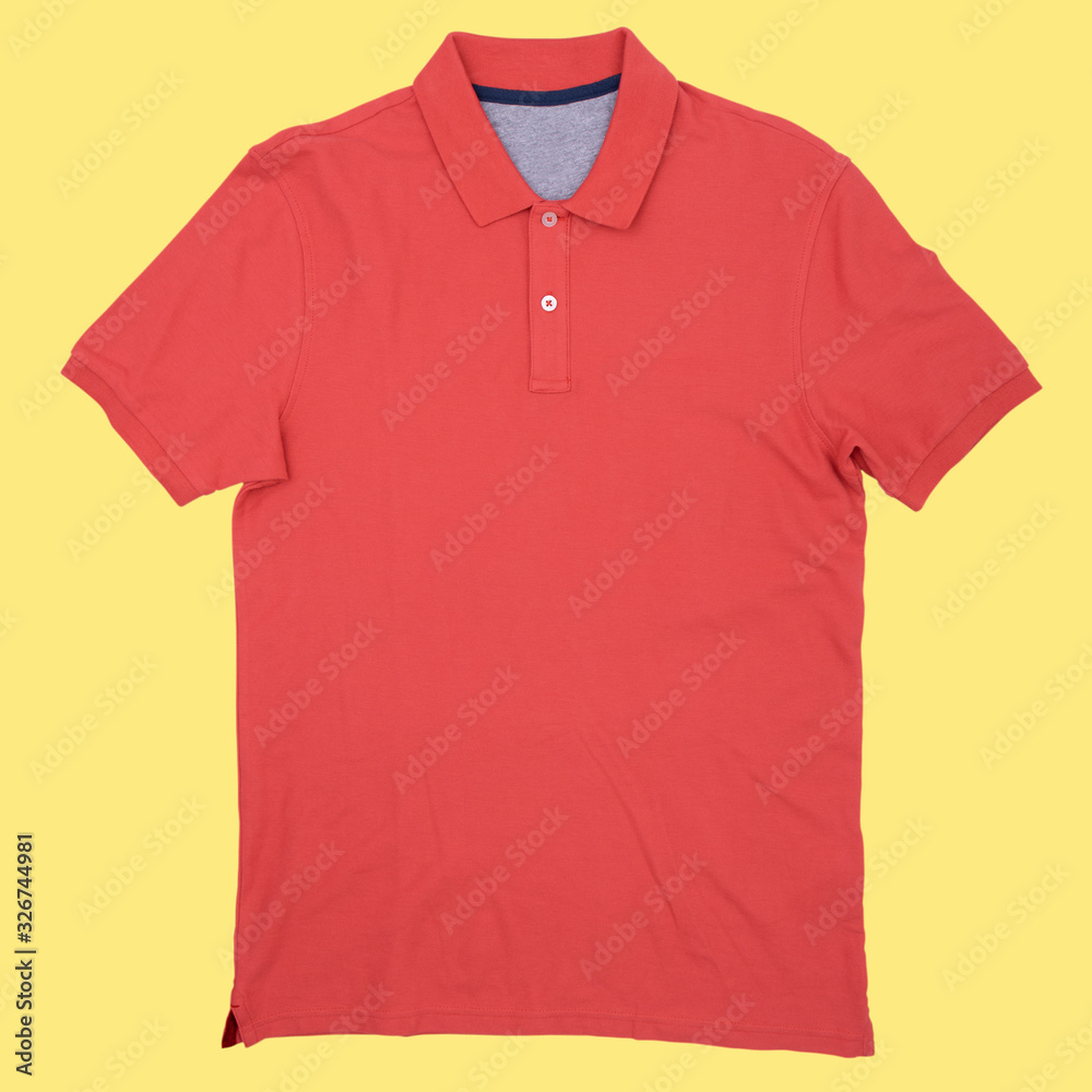 Photo red of an empty polo shirt isolated on a yellow background, isolated. Photo red of an empty polo shirt isolated on a yellow background, isolated.