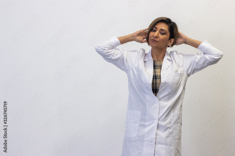 Portrait of relaxed latin young woman model touching his head with both hands, having time for rest, looks quiet and peaceful. Slender charismatic man poses. Doctor, nurse, isolated on white backgroun Portrait of relaxed latin young woman model touching his head with both hands, having time for rest, looks quiet and peaceful. Slender charismatic man poses. Doctor, nurse, isolated on white backgroun