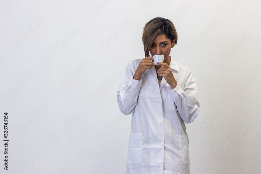 Portrait of attractive young woman model drinking coffee. Pharmacist, therapist, doctor, nurse, scientist, ophthalmologist, veterinarian, healthcare, optometrist, isolated on white background studio s Portrait of attractive young woman model drinking coffee. Pharmacist, therapist, doctor, nurse, scientist, ophthalmologist, veterinarian, healthcare, optometrist, isolated on white background studio s