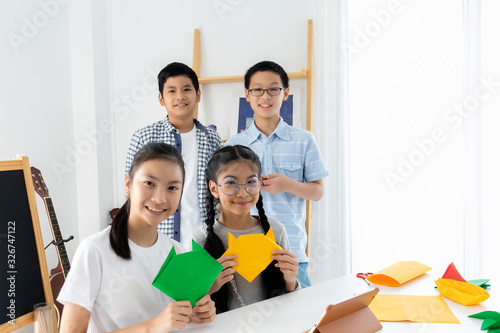 Young diversity Asian students enjoy activity in classroom. Boys, girls learning together by use colorful paper. Integrated school educate children in an environment where self-esteem and independence