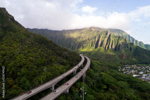 H3 Highway above the forest in Hawaii, sunny day with clouds. Rush hour commute O'ahu