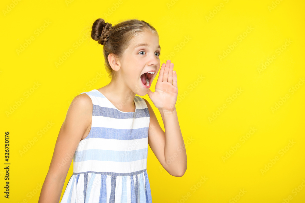 Young beautiful girl screaming on yellow background Young beautiful girl screaming on yellow background