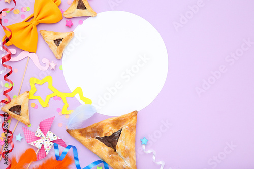 Purim holiday composition. Cookies with party supplies on purple background