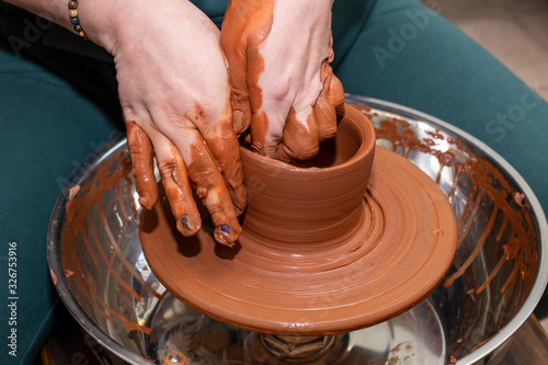 modeling work on pottery wheel hands close-up