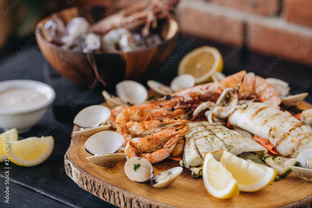 Seafood platter on a black wooden table. Top view