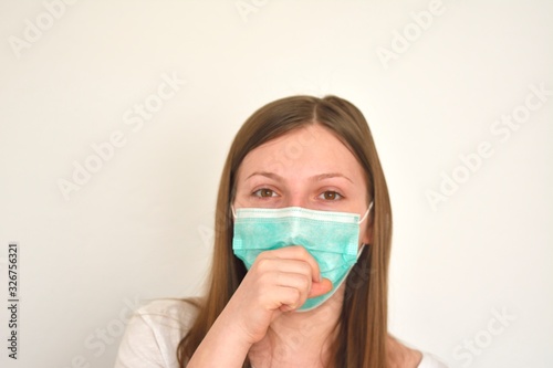 Girl with mask to protect her from Corona virus. Corona virus pandemic. Wuhan coronavirus and epidemic virus symptoms. photo