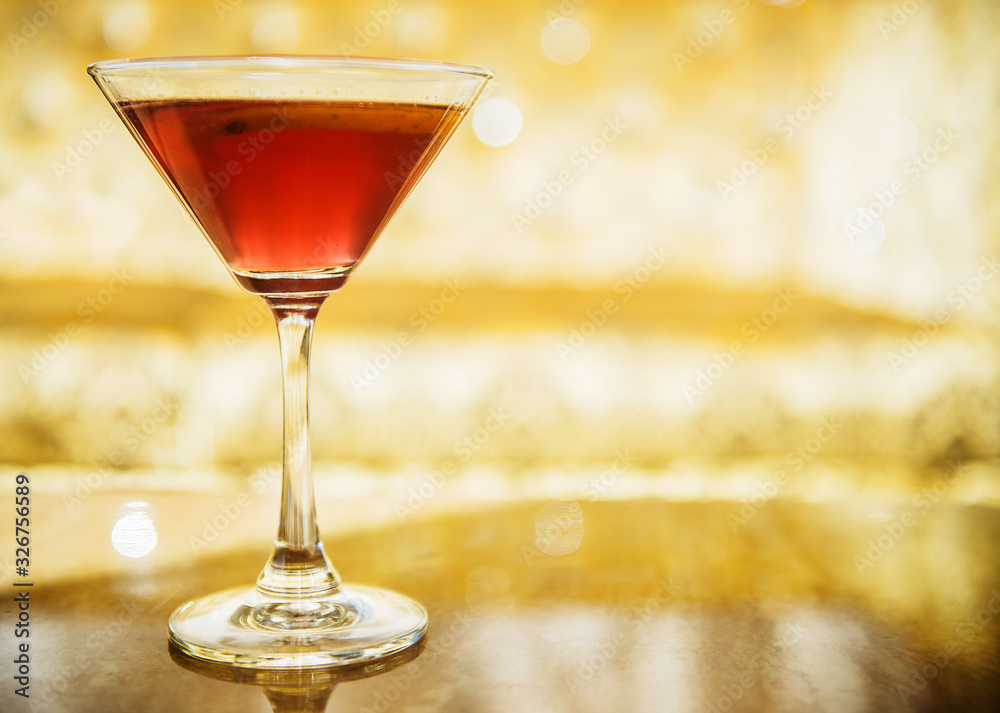 Cosmopolitan cocktail on a gold background Cosmopolitan cocktail on a gold background