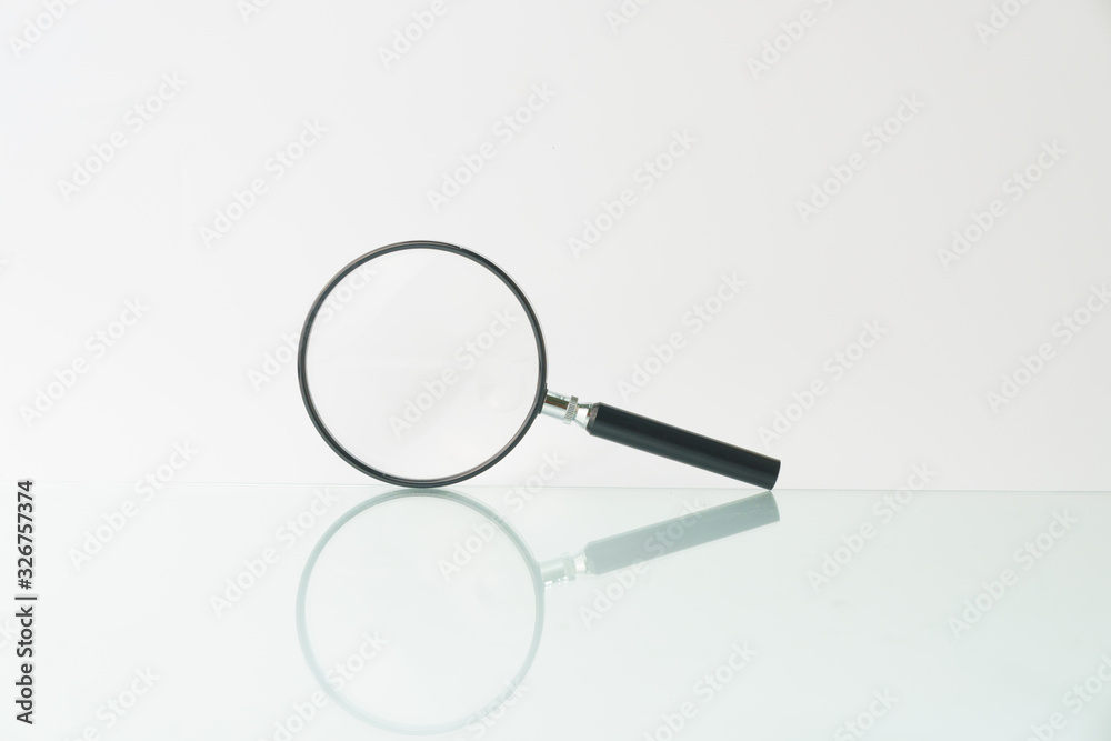 magnifying glass isolated on white background with reflection. copy space. high key magnifying glass isolated on white background with reflection. copy space. high key