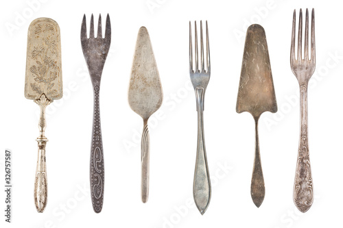 Vintage Silverware, antique spoons, knives, cake shovels isolated on isolated white background. Antique silverware. Retro.
