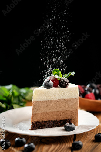 Cuadro en lienzo Piece of light mousse cake with fruits on on wooden surface