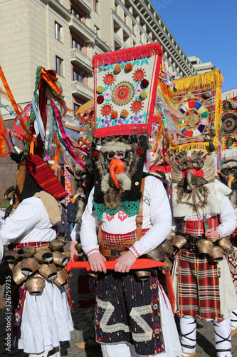 Moscow Maslenitsa Festival, Russia. Traditional national celebration in folk style. Slavic tradition. Ornamental masks of masked kukers from Bulgaria. Costumes of Bulgarian artists. Ethnic ornament photo