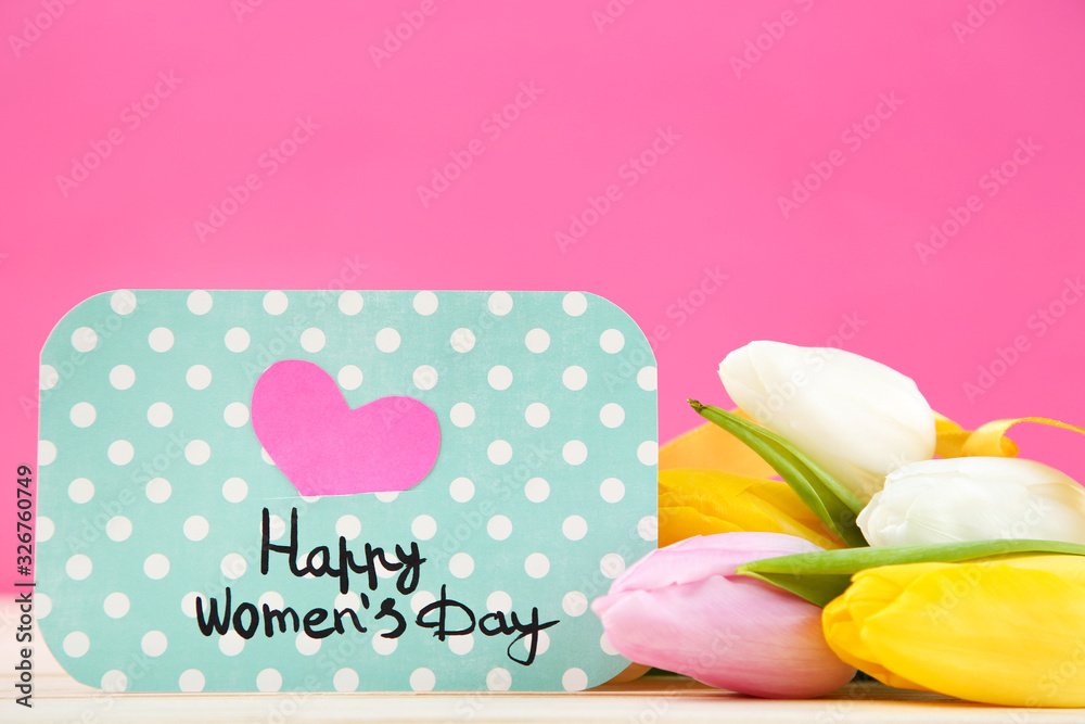 Text Happy Womens Day with tulip flowers on pink background