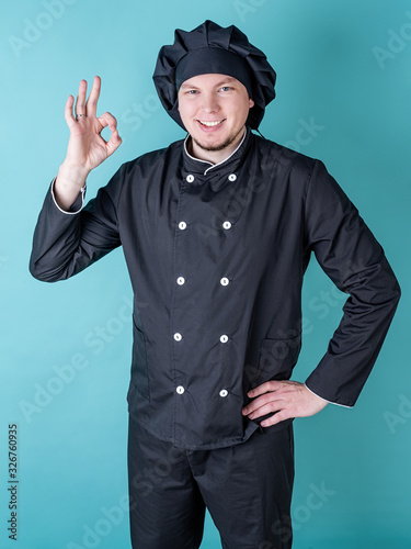 Male chef showing ok sign isolated on blue background