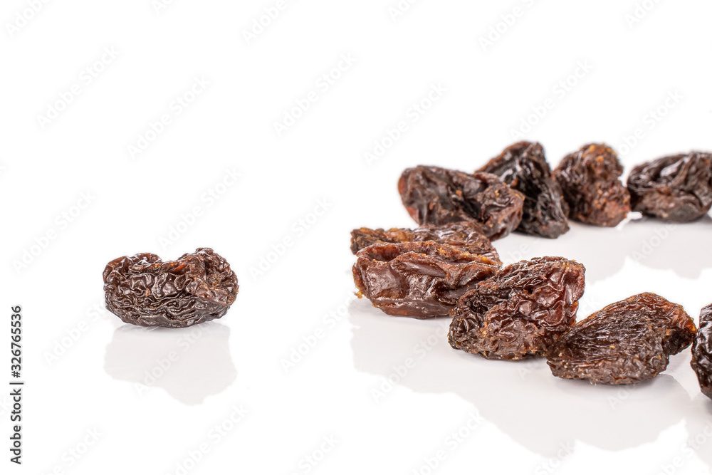 Lot of whole sweet dried dark raisin isolated on white background Lot of whole sweet dried dark raisin isolated on white background