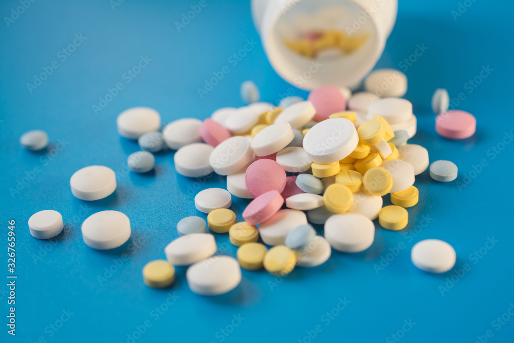 Tablets to maintain the correct functioning of the human cardiovascular system on a blue background Tablets to maintain the correct functioning of the human cardiovascular system on a blue background