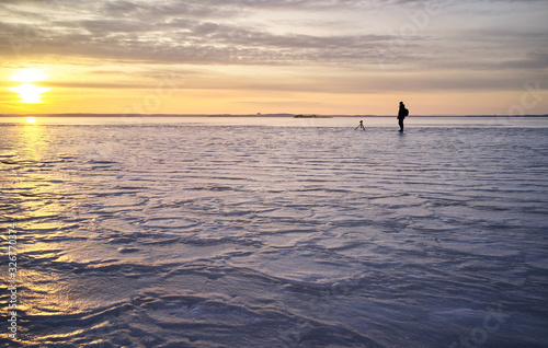 Photographer taking photos on frozen lake