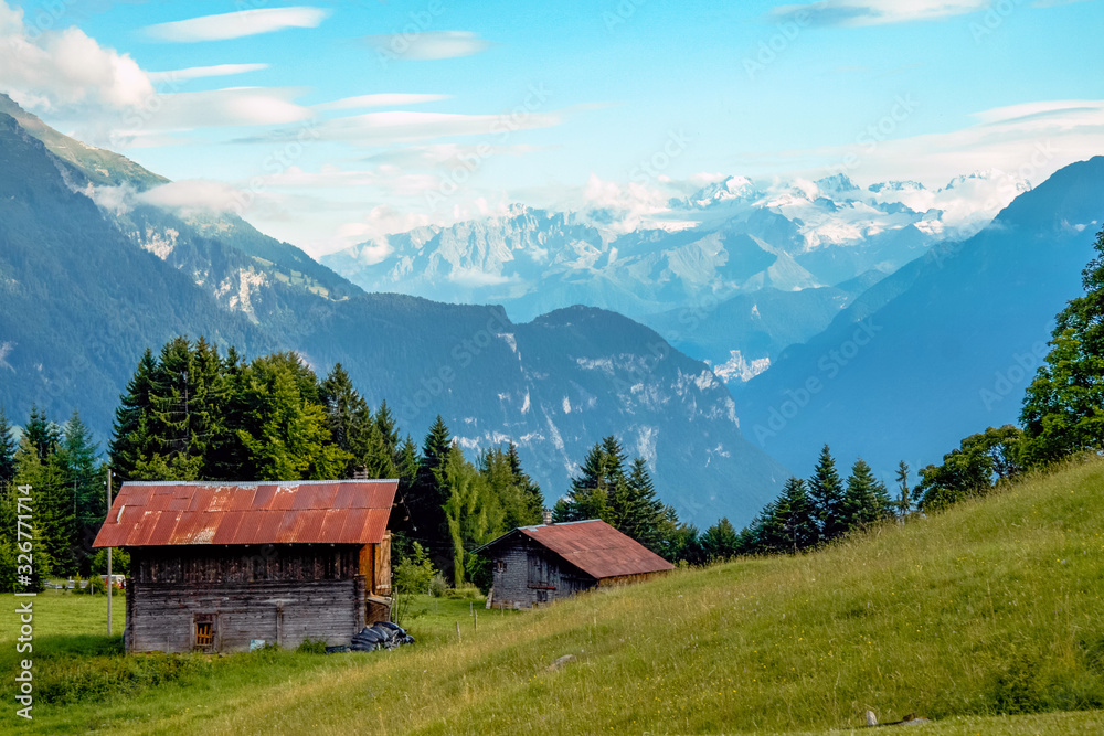 Villars-sur-Ollon, Vaud / Switzerland: Swiss landscape in summer with the snowy Alps in the background