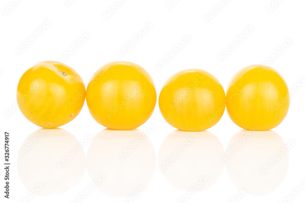 Group of four whole fresh yellow tomato line isolated on white background