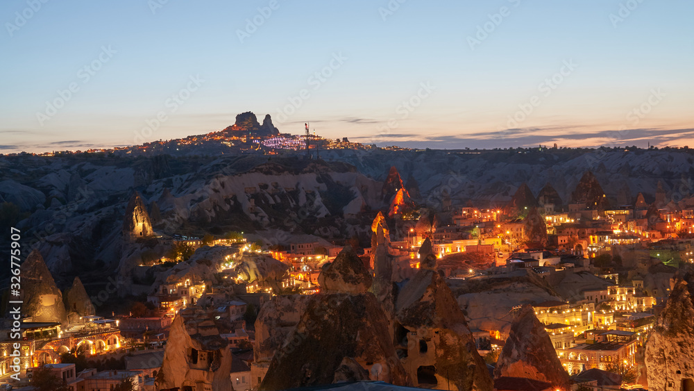 Goreme town and Uchisar castle in the background at night in Cappadocia, Anatolia, Turkey. 
