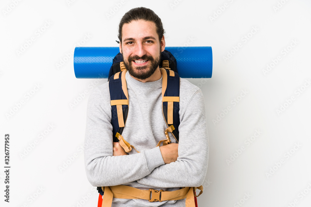 Young backpacker man isolated on a white background laughing and having fun. Young backpacker man isolated on a white background laughing and having fun.