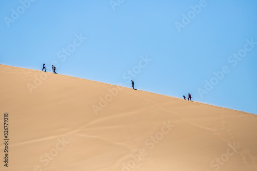 climbing the dune. singing dune in kazakhstan