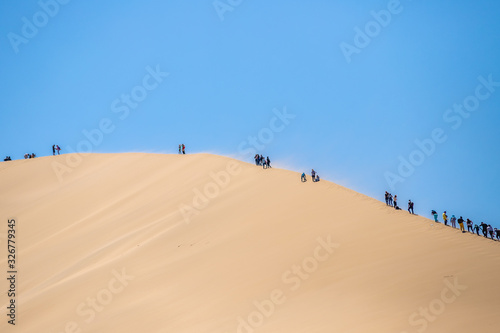 climbing the dune. singing dune in kazakhstan