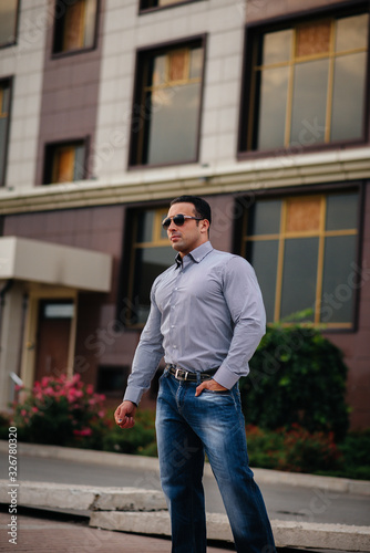 Young successful man near an office building. Business © Andrii