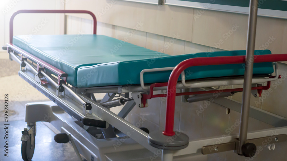 bed wheelchair for patients in the emergency room of the hospital. stretcher gurney bed in hospital corridor bed wheelchair for patients in the emergency room of the hospital. stretcher gurney bed in hospital corridor