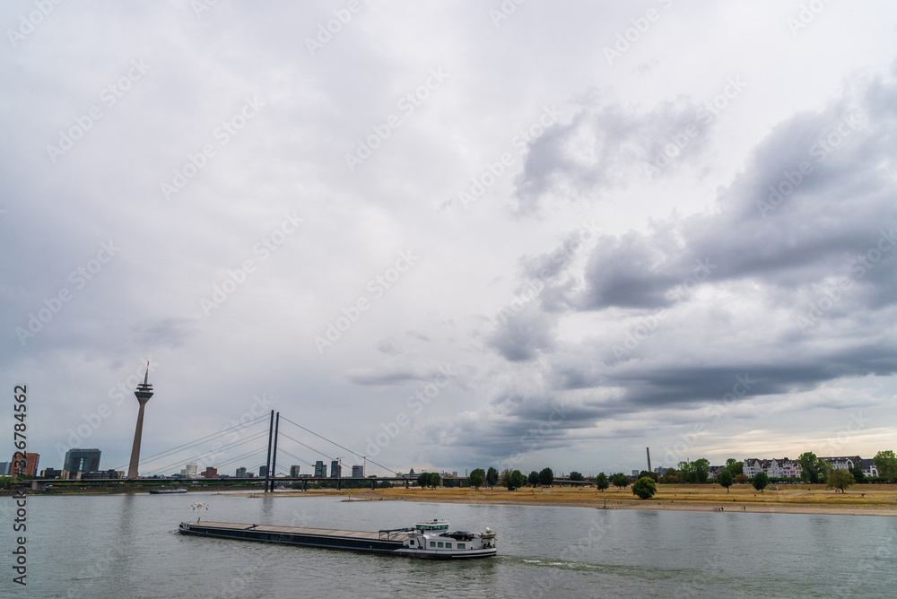 View at Rheinknie bridge, Rhine river, Rheinthurm telecommunications tower, and Medienhafen district in Dusseldorf, Germany