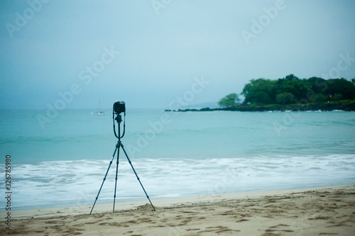 A camera on the tripod by the beach
