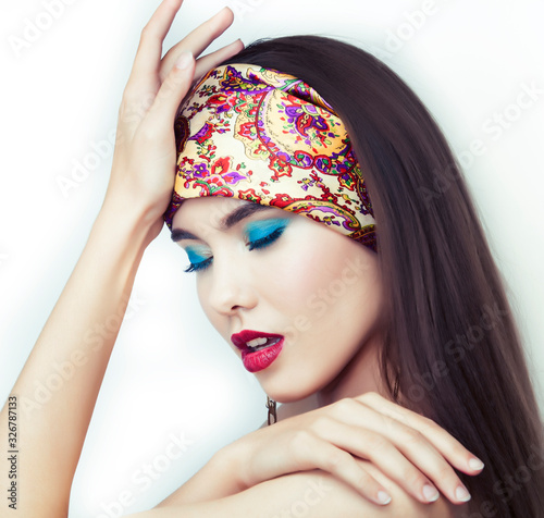 young pretty modern girl with bright shawl on head emotional posing isolated on white background, asian people ethnicity photo