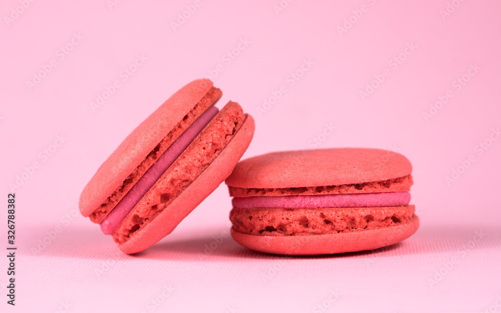 .pink macaroons on a pink background close-up