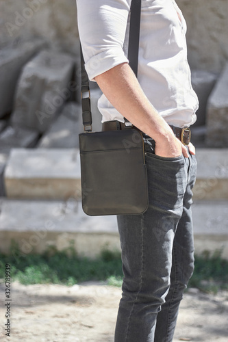 Man with a leather black bag on the street