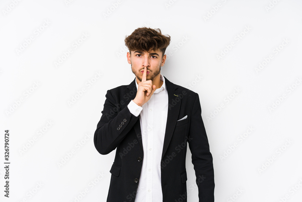 Young arabian business man isolated keeping a secret or asking for silence. Young arabian business man isolated keeping a secret or asking for silence.