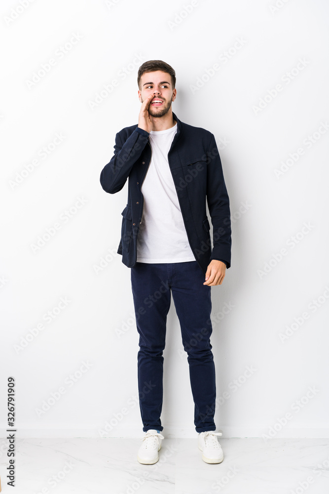 Full body young caucasian man isolated is saying a secret hot braking news and looking aside Full body young caucasian man isolated is saying a secret hot braking news and looking aside