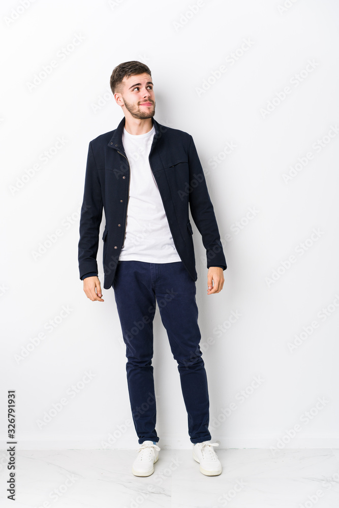 Full body young caucasian man isolated dreaming of achieving goals and purposes Full body young caucasian man isolated dreaming of achieving goals and purposes