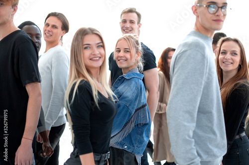 casual young woman standing among diverse young people.