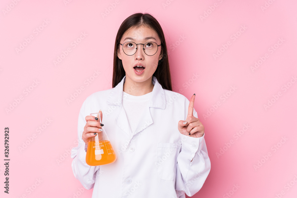 Young chinese scientific woman isolated pointing upside with opened mouth. Young chinese scientific woman isolated pointing upside with opened mouth.