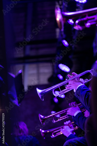 Photography The trumpet section of a big band is playing a chorus during a concert on stage