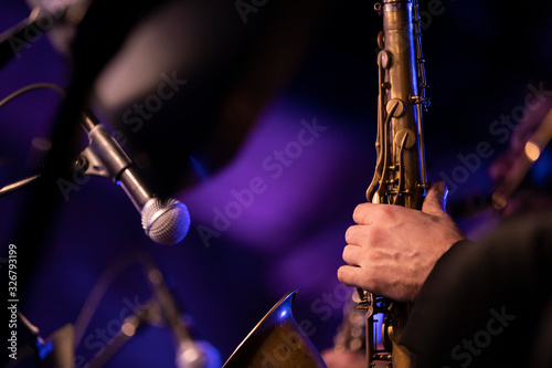Canvas Print A tenor saxophone player playing their horn with a microphone pointing into the