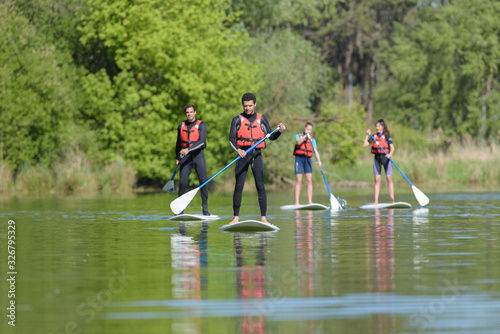 Photography group of people stand up paddleboarding