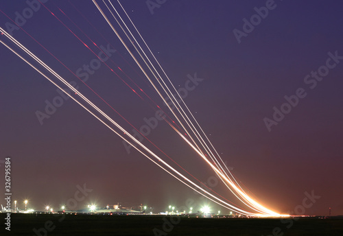 Long time exposure of taking off and landing aircrafts  forming a curves in the sky © Timofey Astakhov
