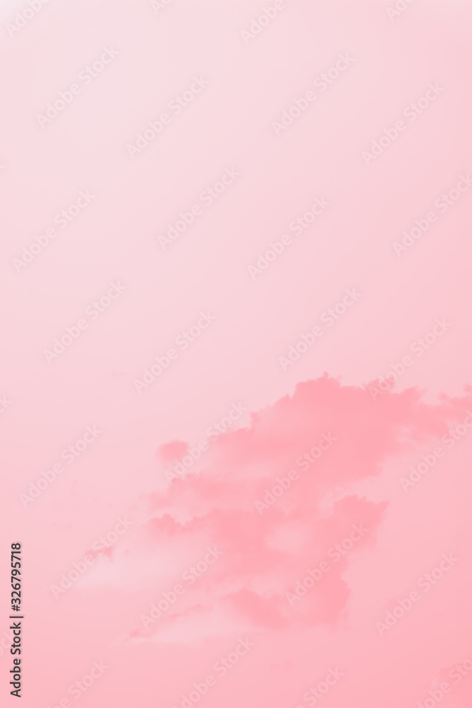 Scenic sky. Beautiful soft fluffy clouds on a clear sky background. Pink coral toned, copy space